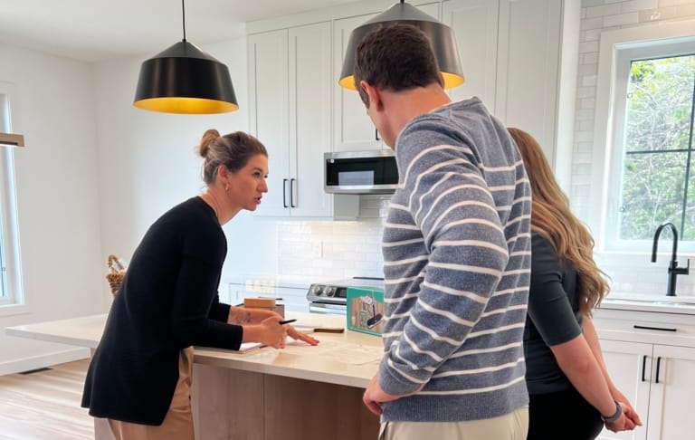 A customer and Lexis Homes reviewing a document